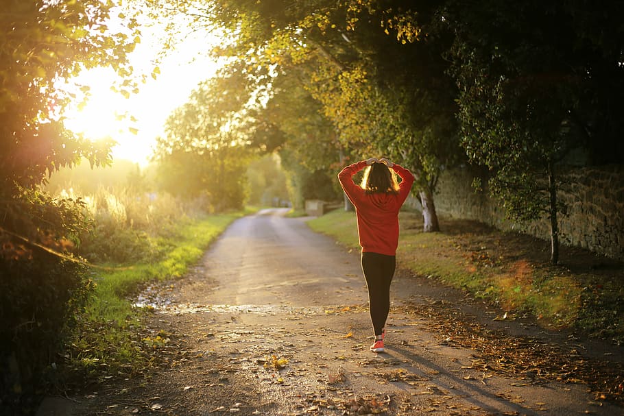 woman walking on road.