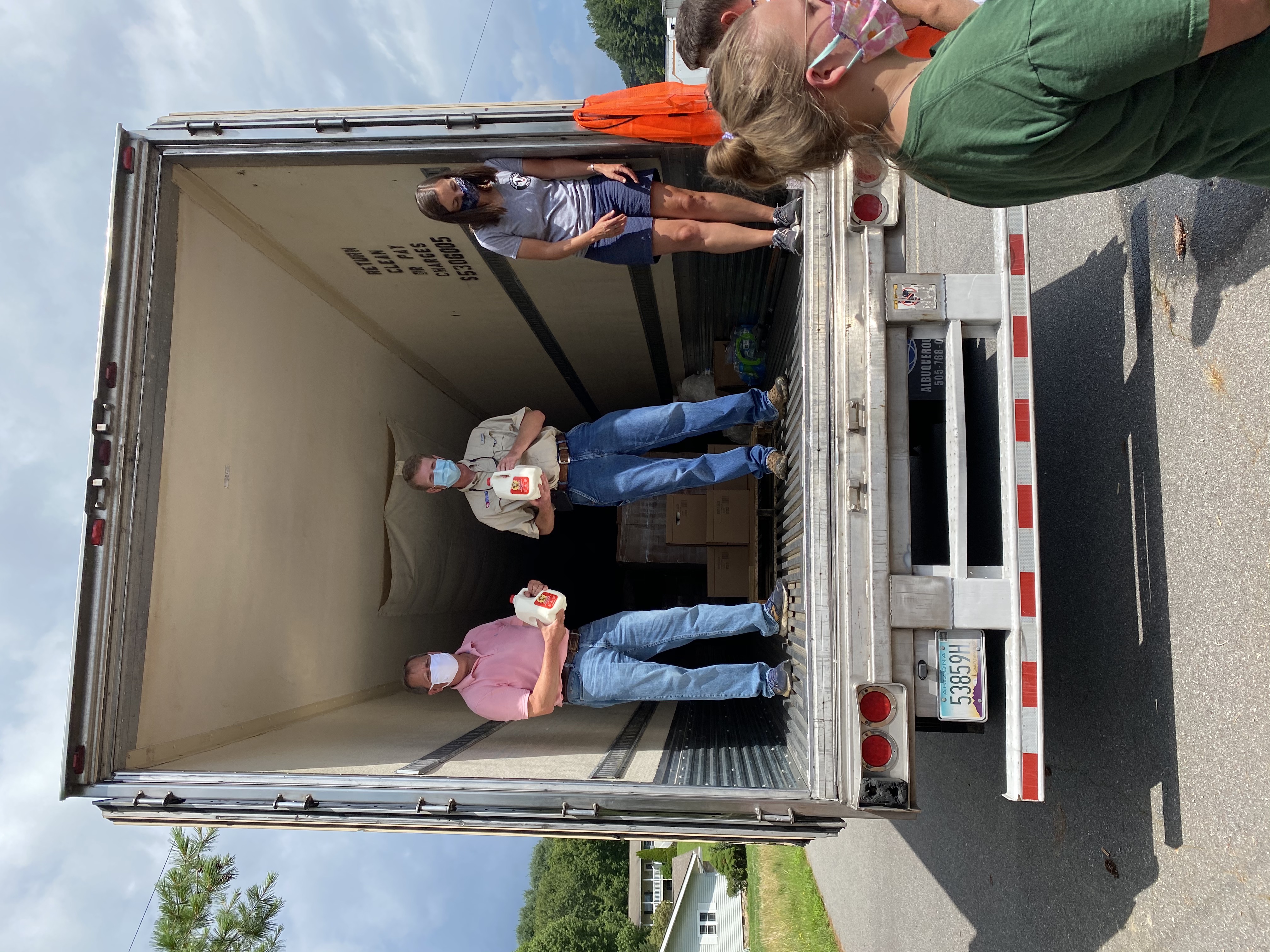 Bill Skelton, Ethan Henderson, Elizabeth Moretz offloading milk from Borden Dairy truck
