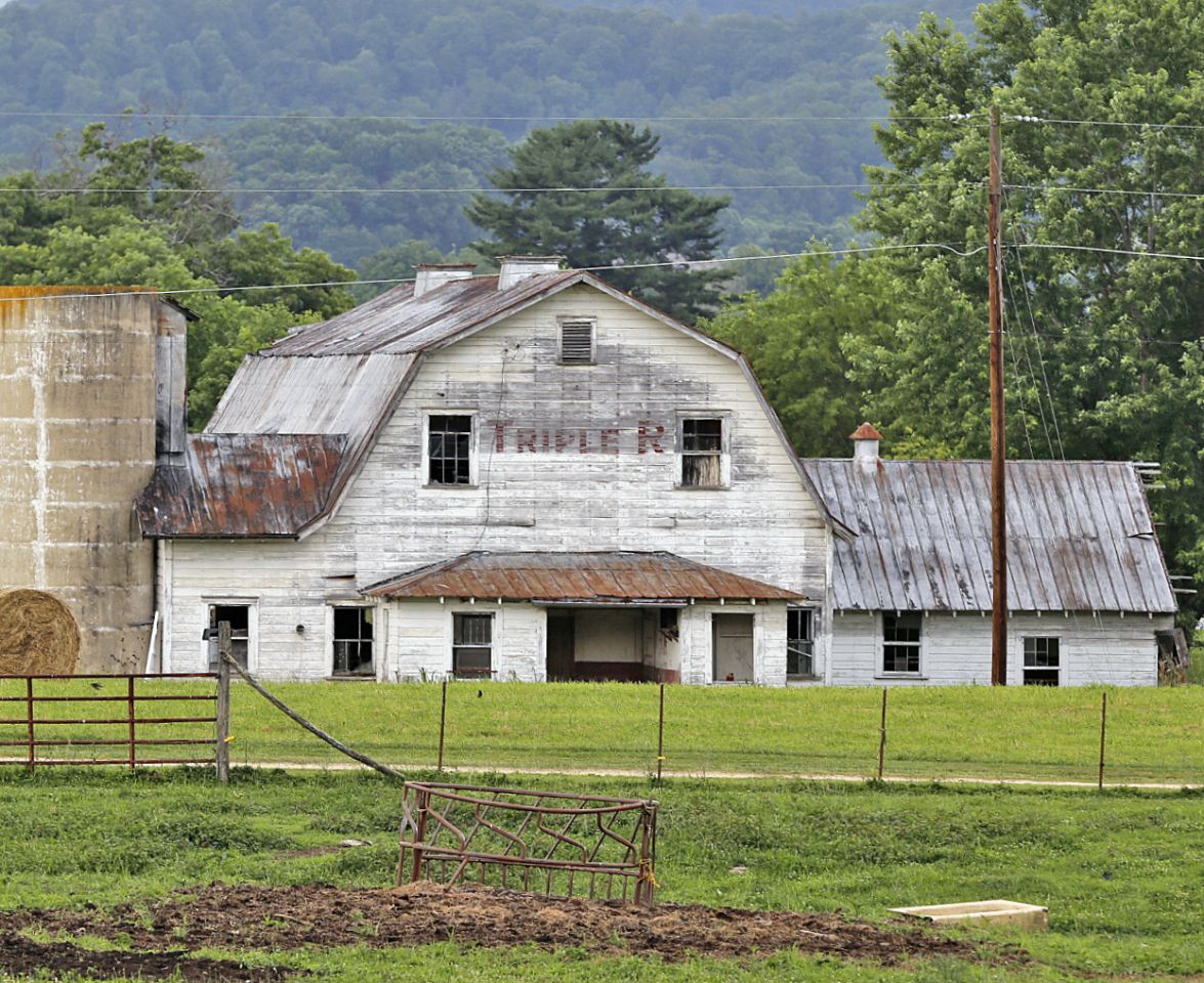 An older barn with faded signage reading Triple R.